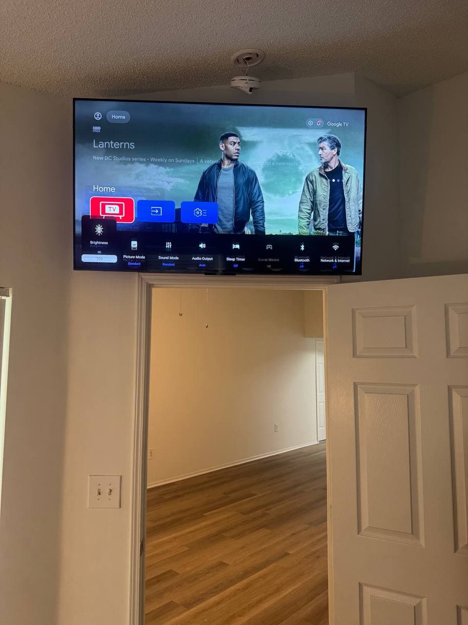 55-Inch TV Mounted Above a Doorway in Coconut Creek, FL