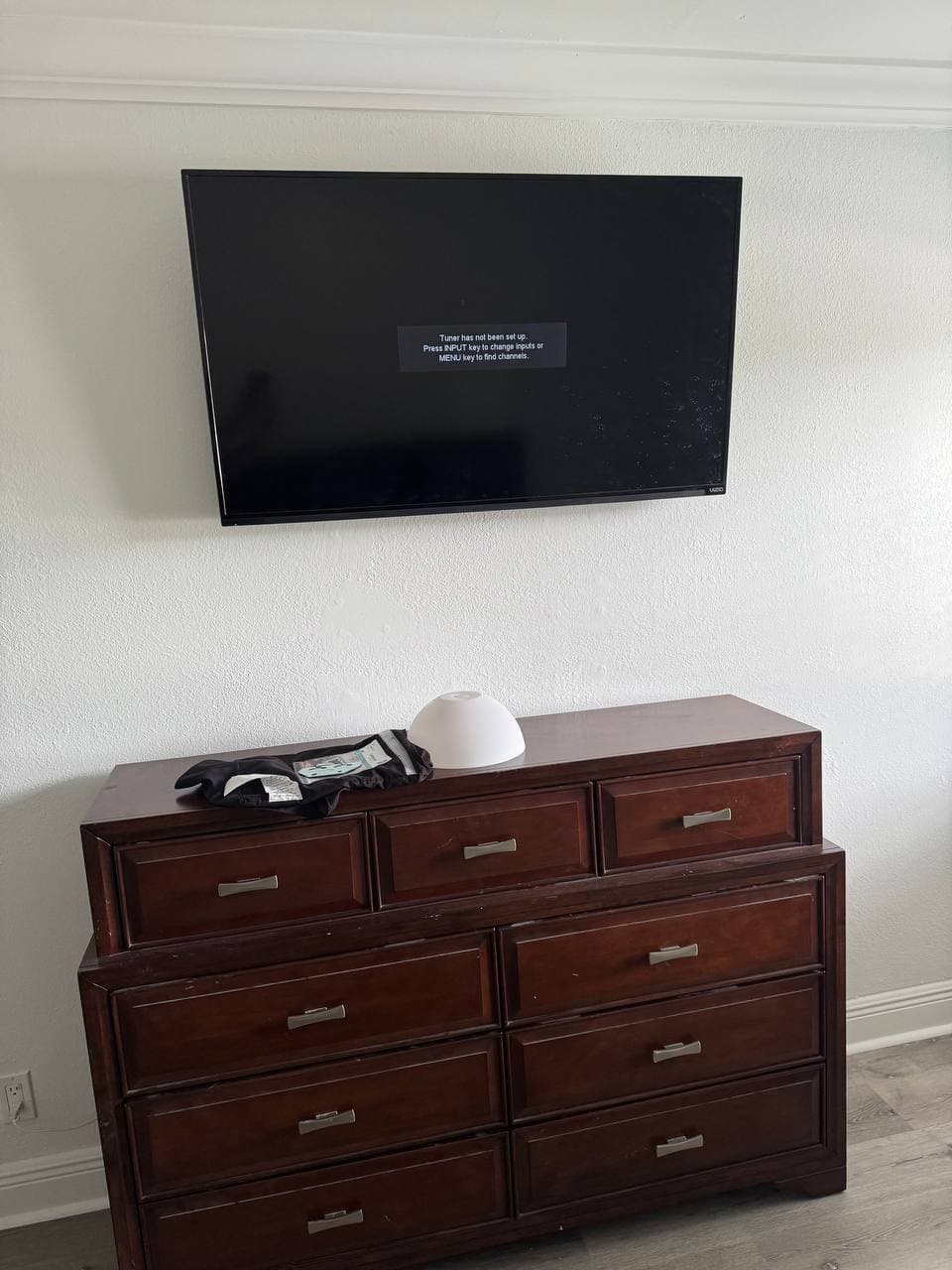 43-Inch TV Mounted Over a Bedroom Dresser in Coconut Creek, FL
